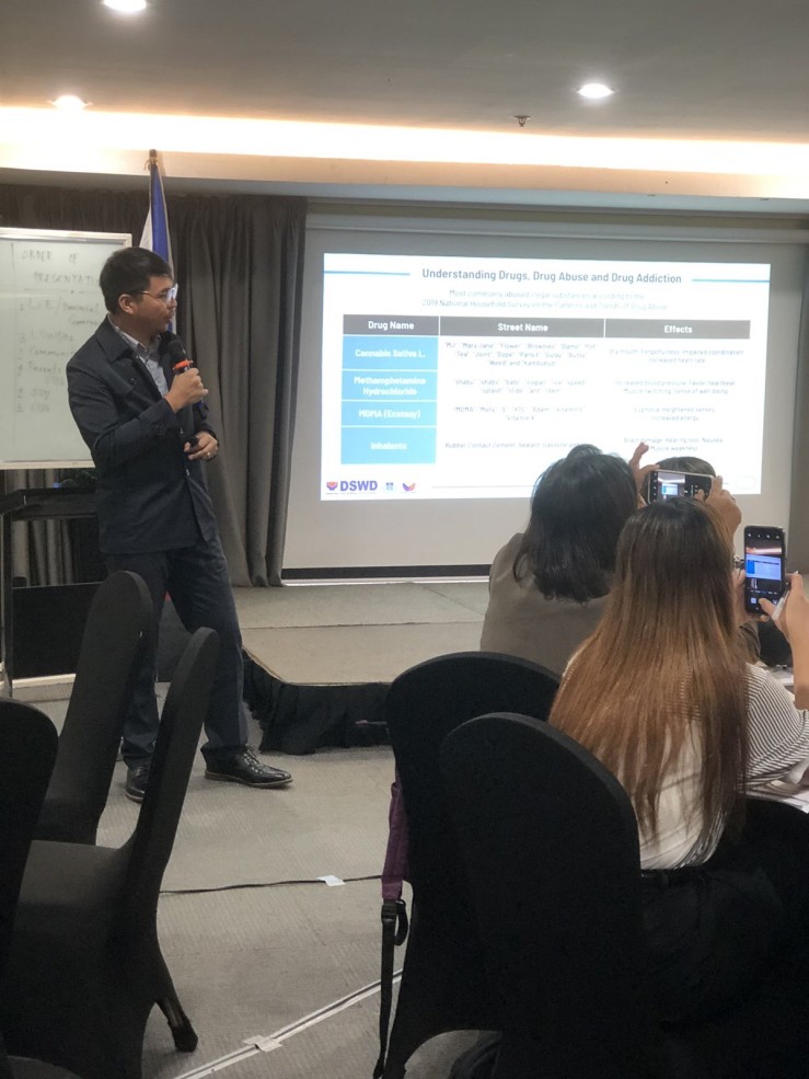 Dr. Paul Lawrence Filomeno stands to the side as he explains his presentation. 